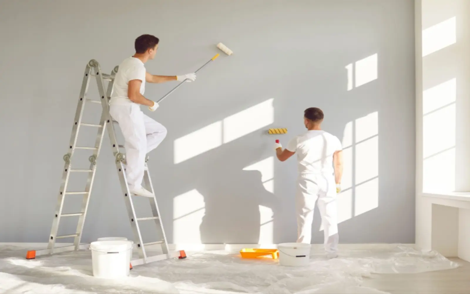 Painters applying a clean interior wall finish