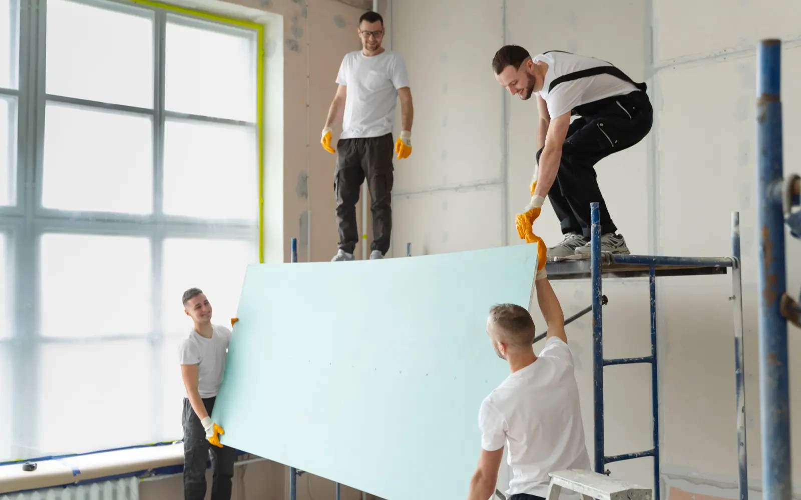 Interior renovation team positioning a light partition panel
